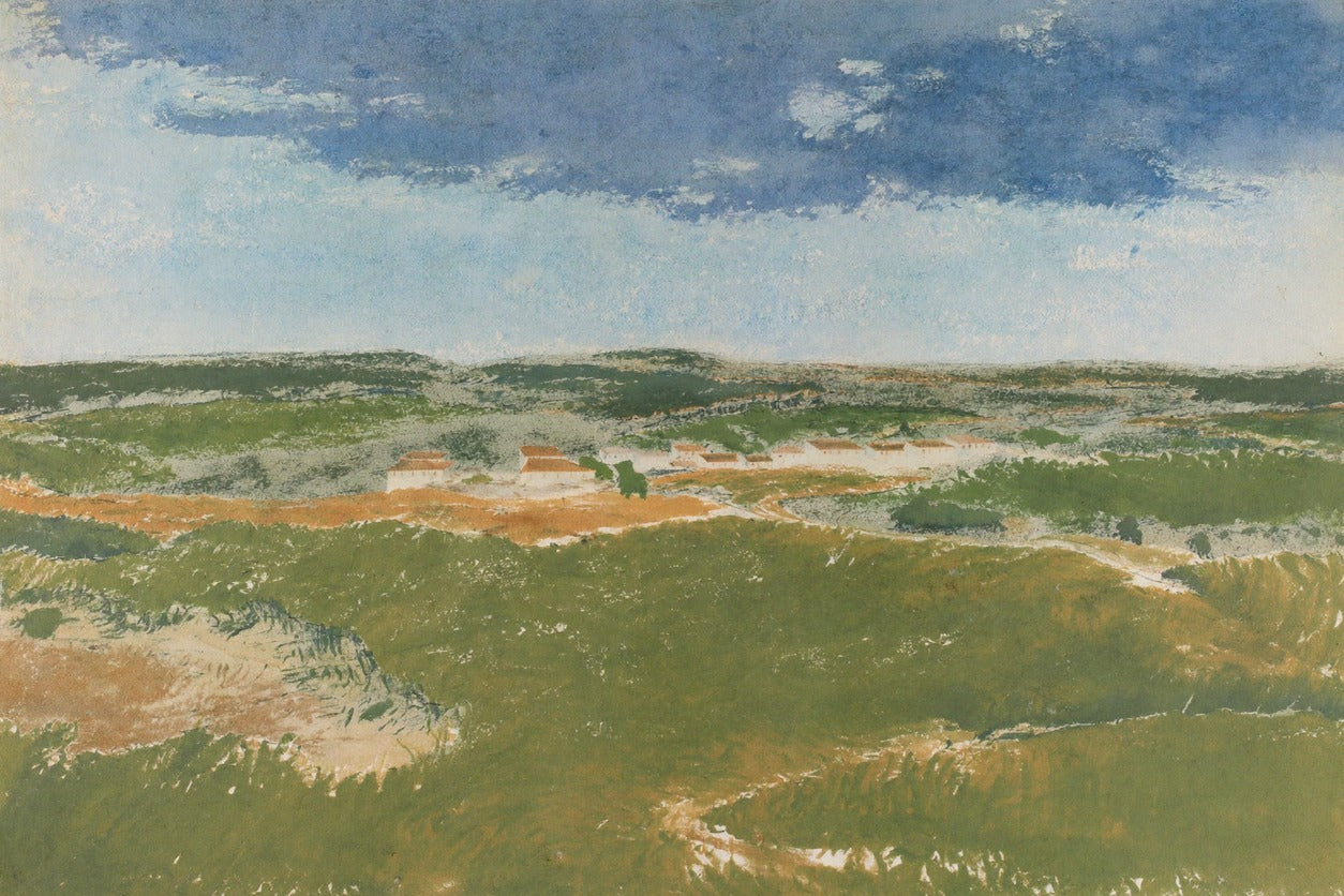 Green dunes and pale sand beneath a broad blue sky with small white buildings on the horizon