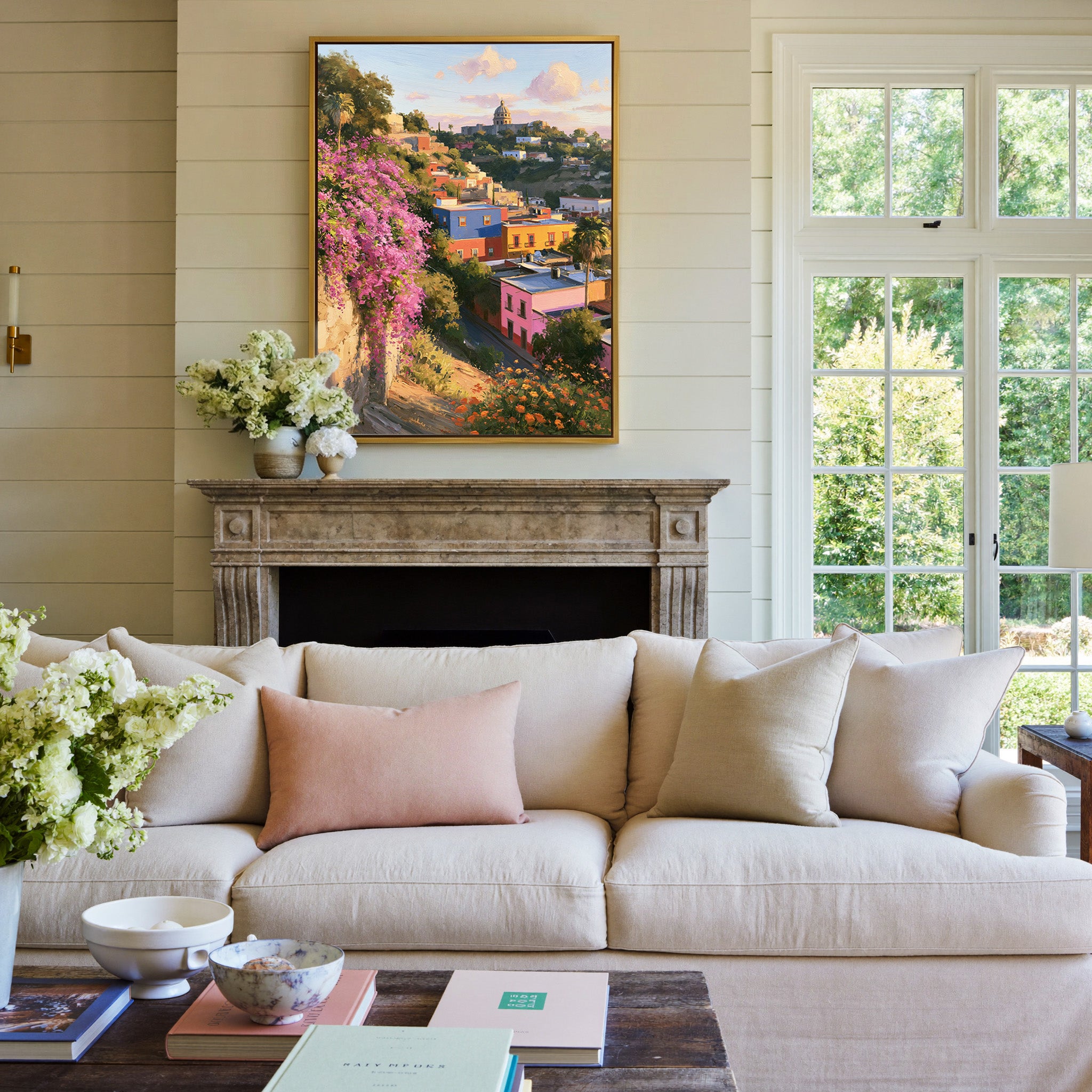 colorful hillside town with a domed church and canvas wall art in a gold frame above a mantel