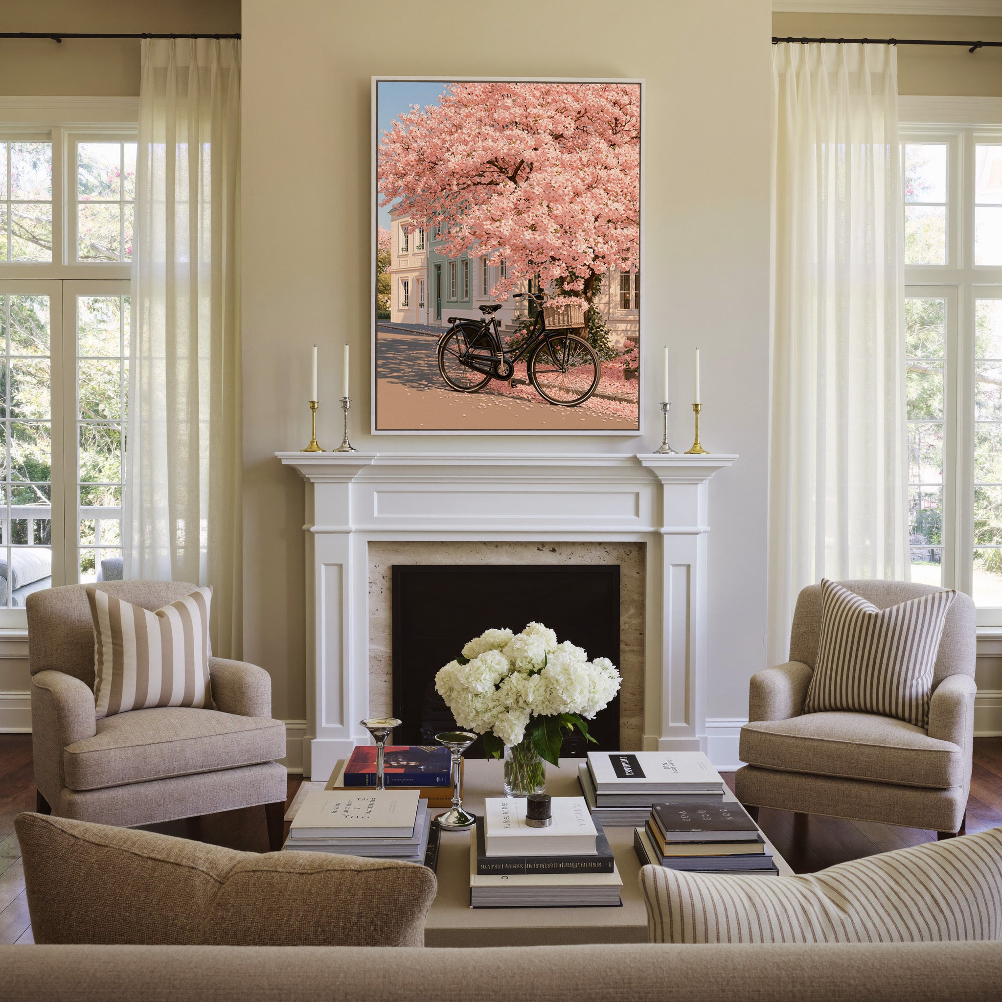 black bicycle beneath pink blossoms canvas wall art in a white frame above a mantel