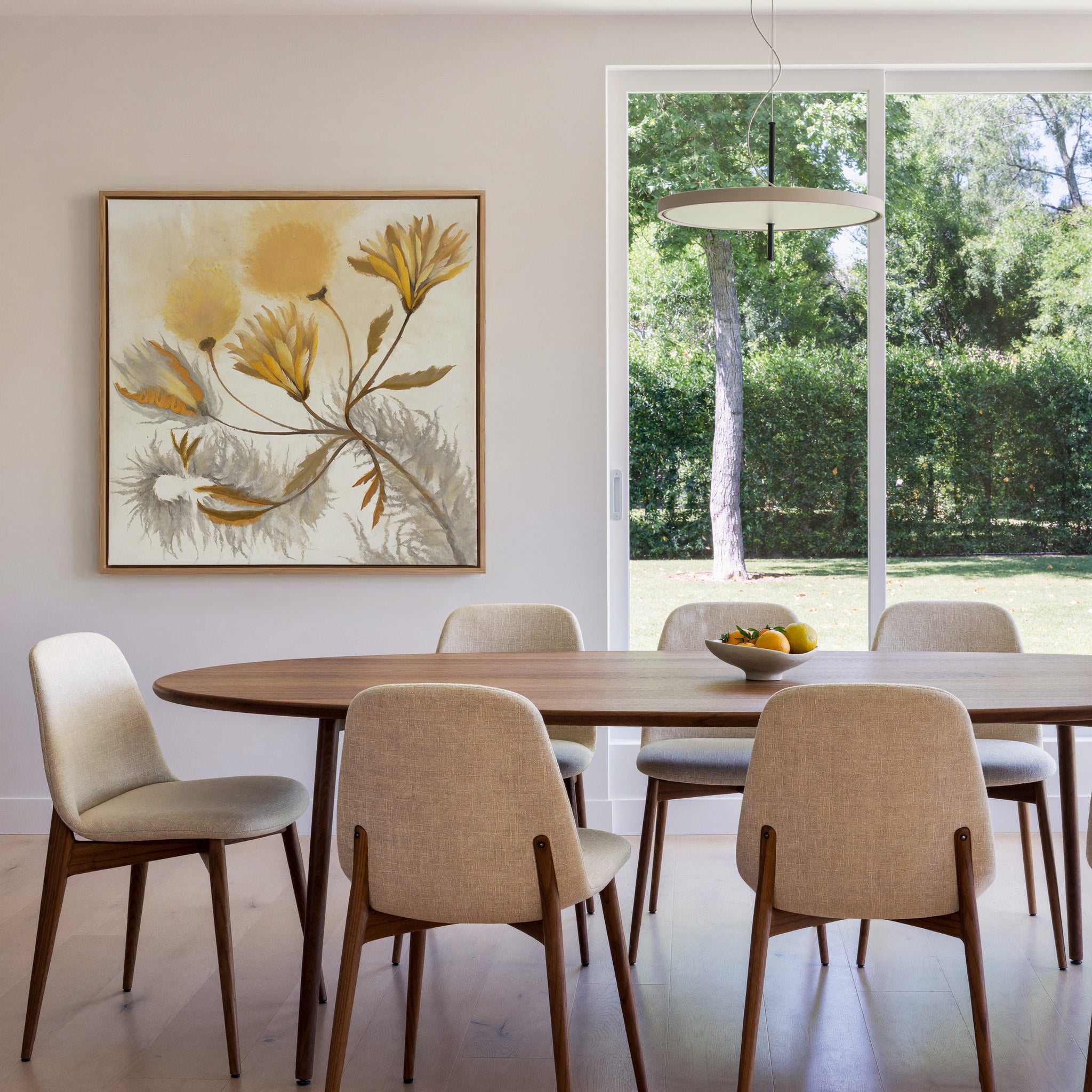 soft ochre and gray abstract canvas wall art in an oak frame in a dining room