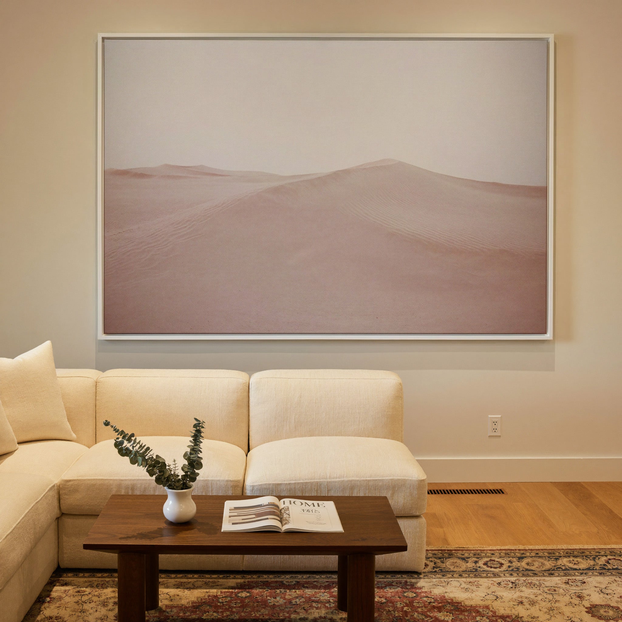 soft blush desert dunes canvas wall art in a white frame in a styled room setting