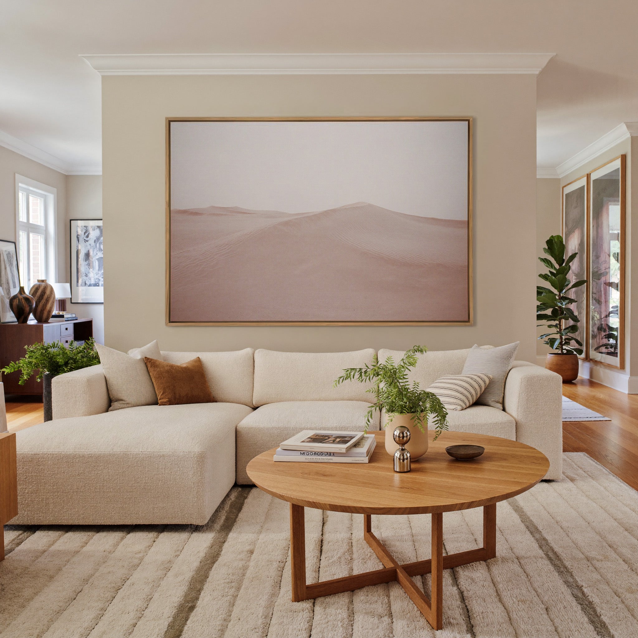 soft blush desert dunes canvas wall art in an oak frame in a living room