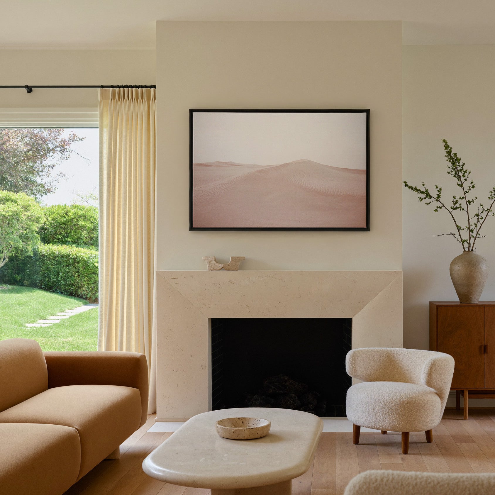 soft blush desert dunes canvas wall art in a black frame above a mantel