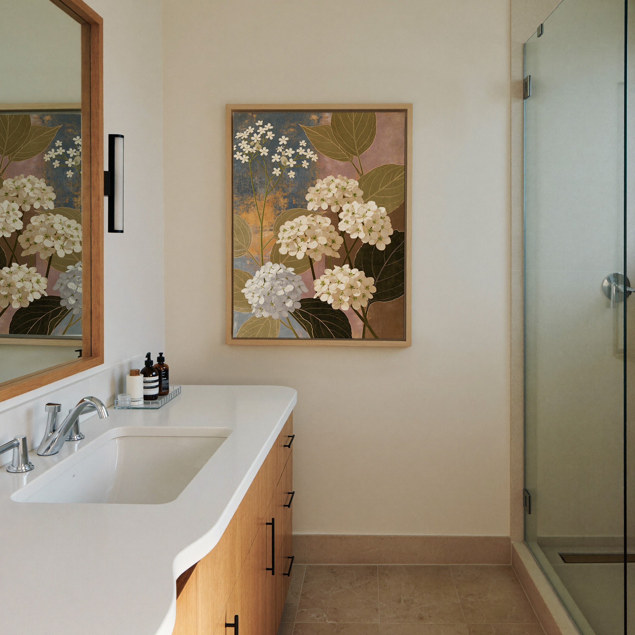 white hydrangea clusters with olive leaves on canvas wall art in a natural wood frame in a styled room setting