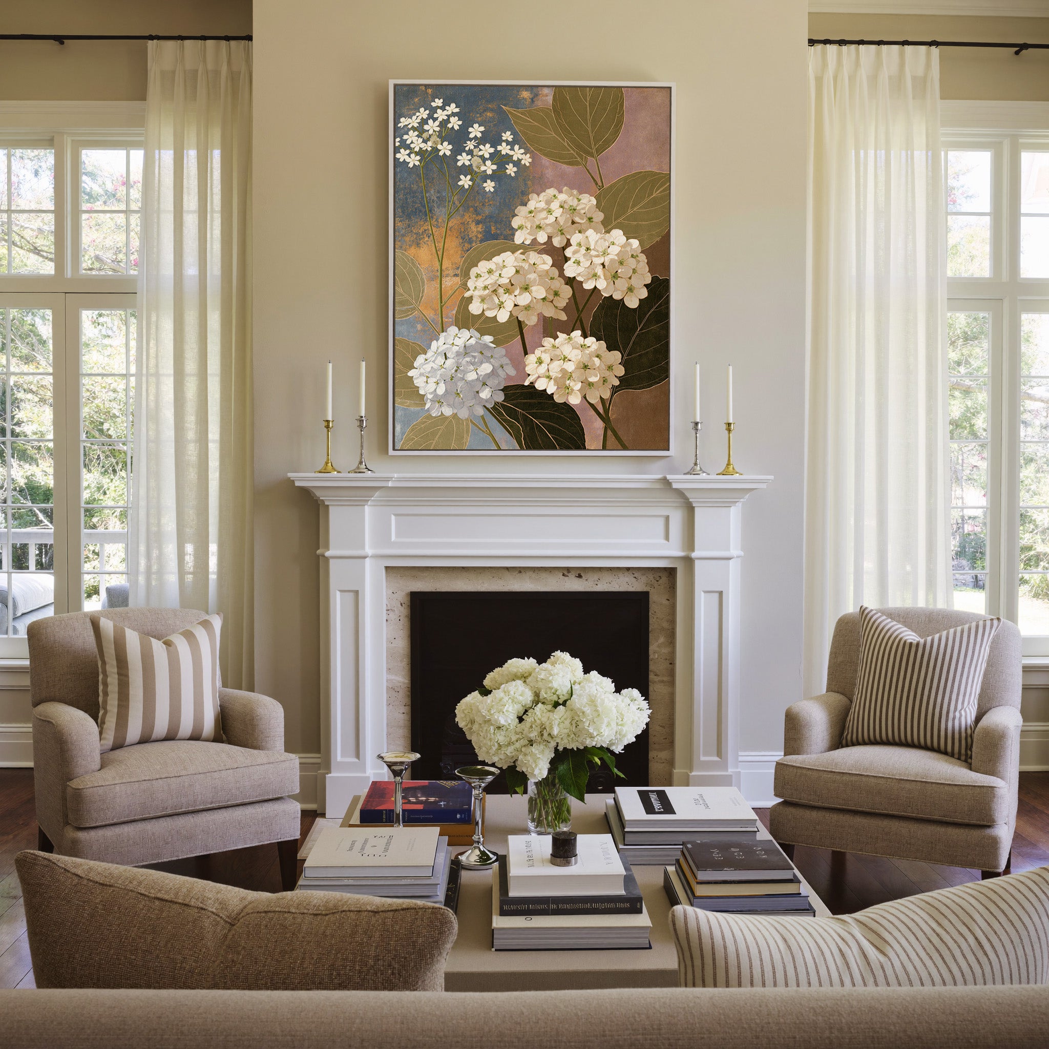 white hydrangea clusters with olive leaves on canvas wall art in a white frame above a mantel