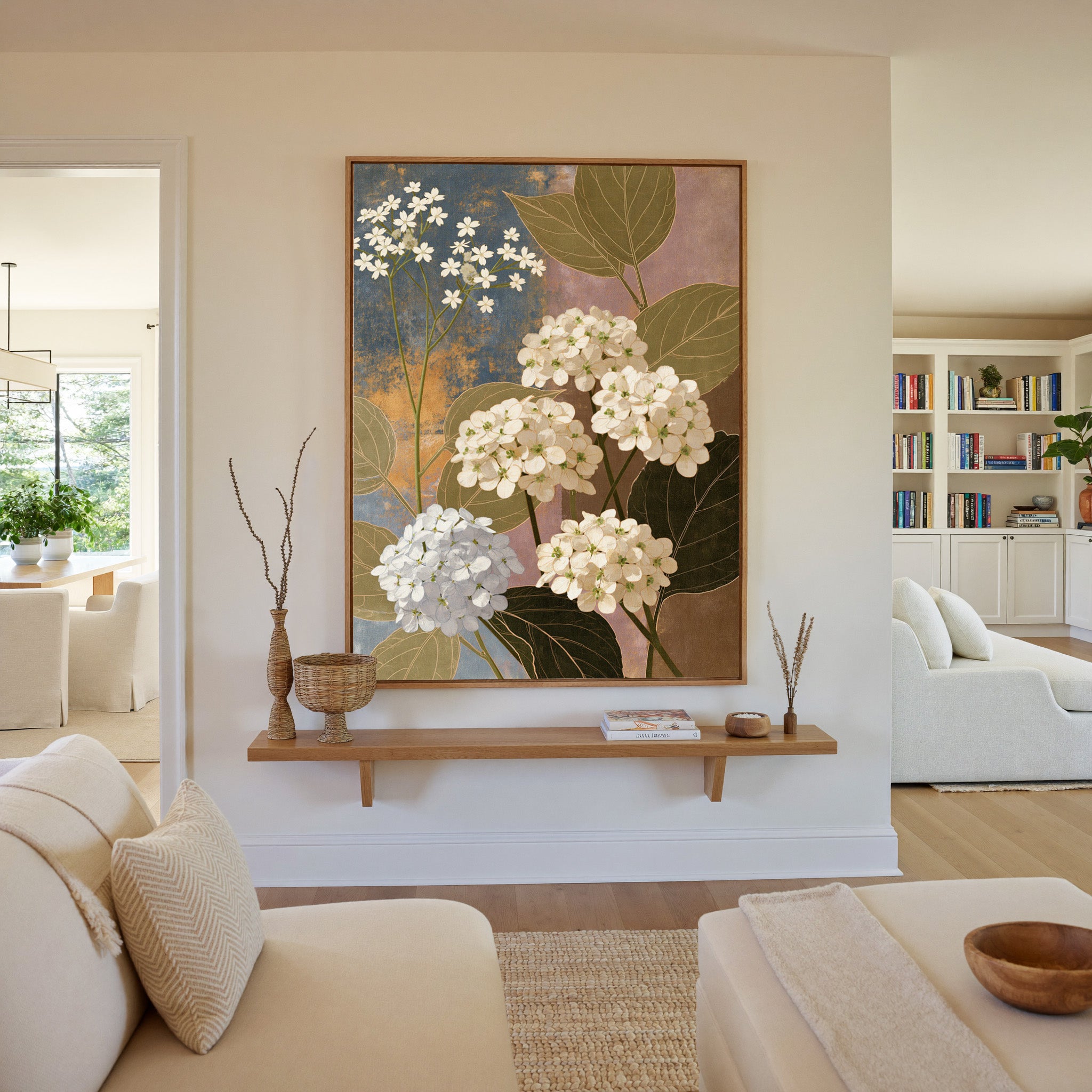 white hydrangea clusters with olive leaves on canvas wall art in an oak frame in a living room