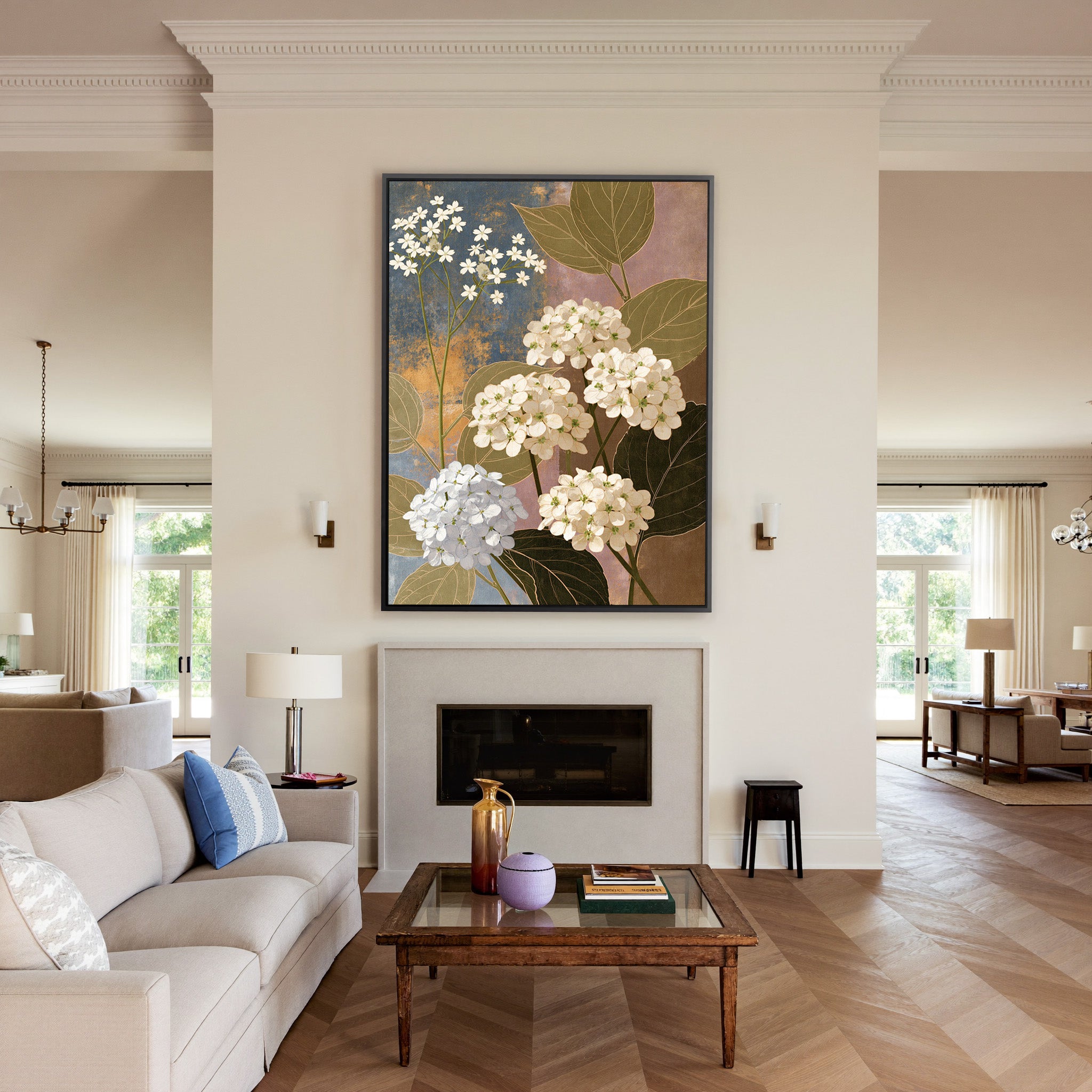 white hydrangea clusters with olive leaves on canvas wall art in a black frame above a mantel