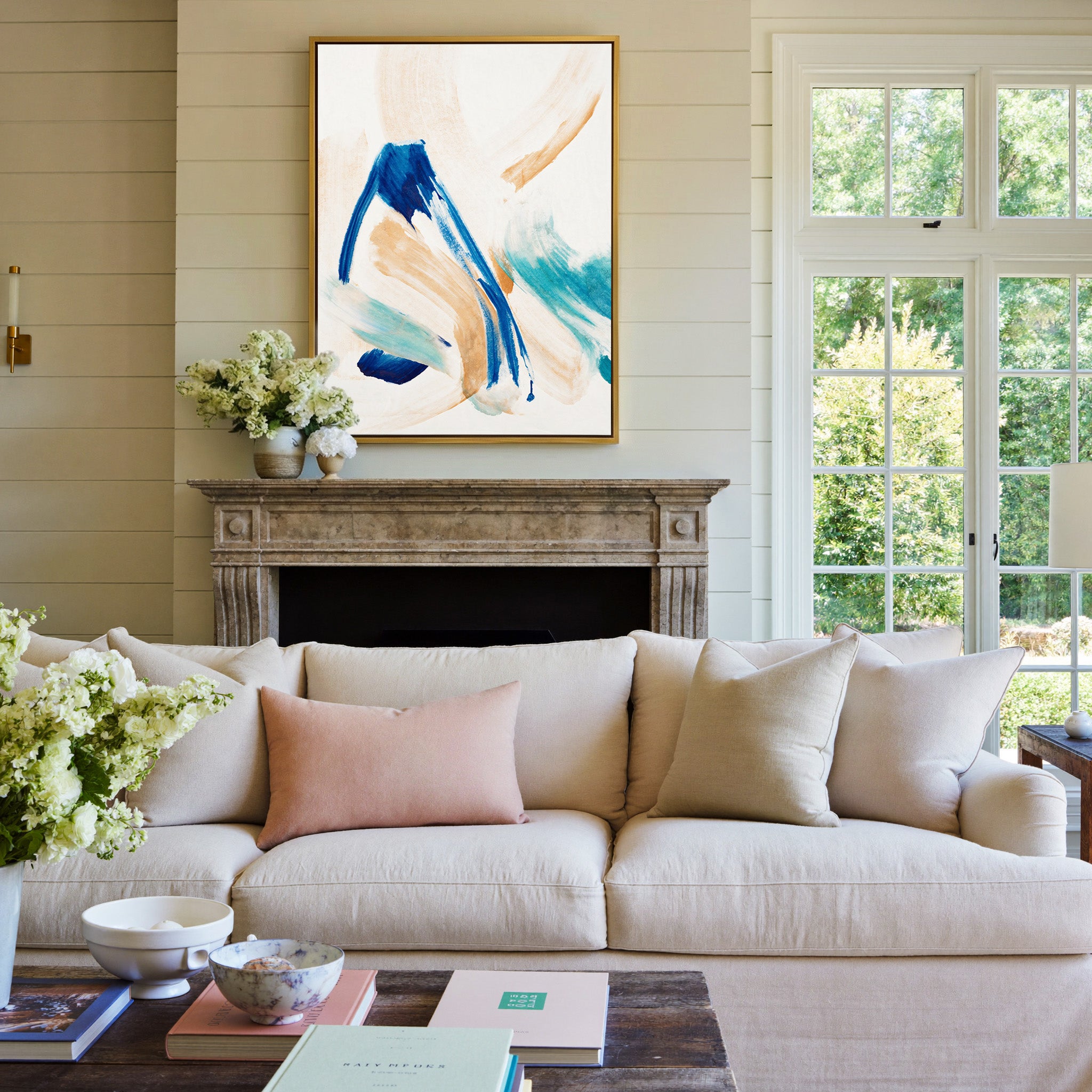 blue, aqua, and warm beige abstract with canvas wall art in a gold frame above a mantel