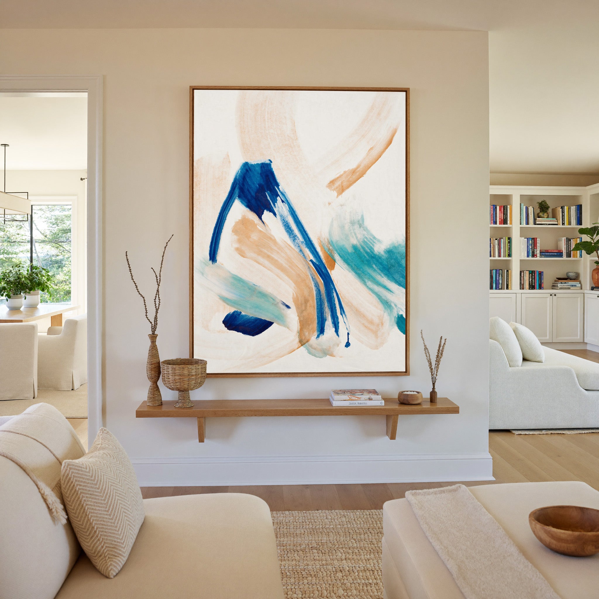 blue, aqua, and warm beige abstract with canvas wall art in an oak frame in a living room
