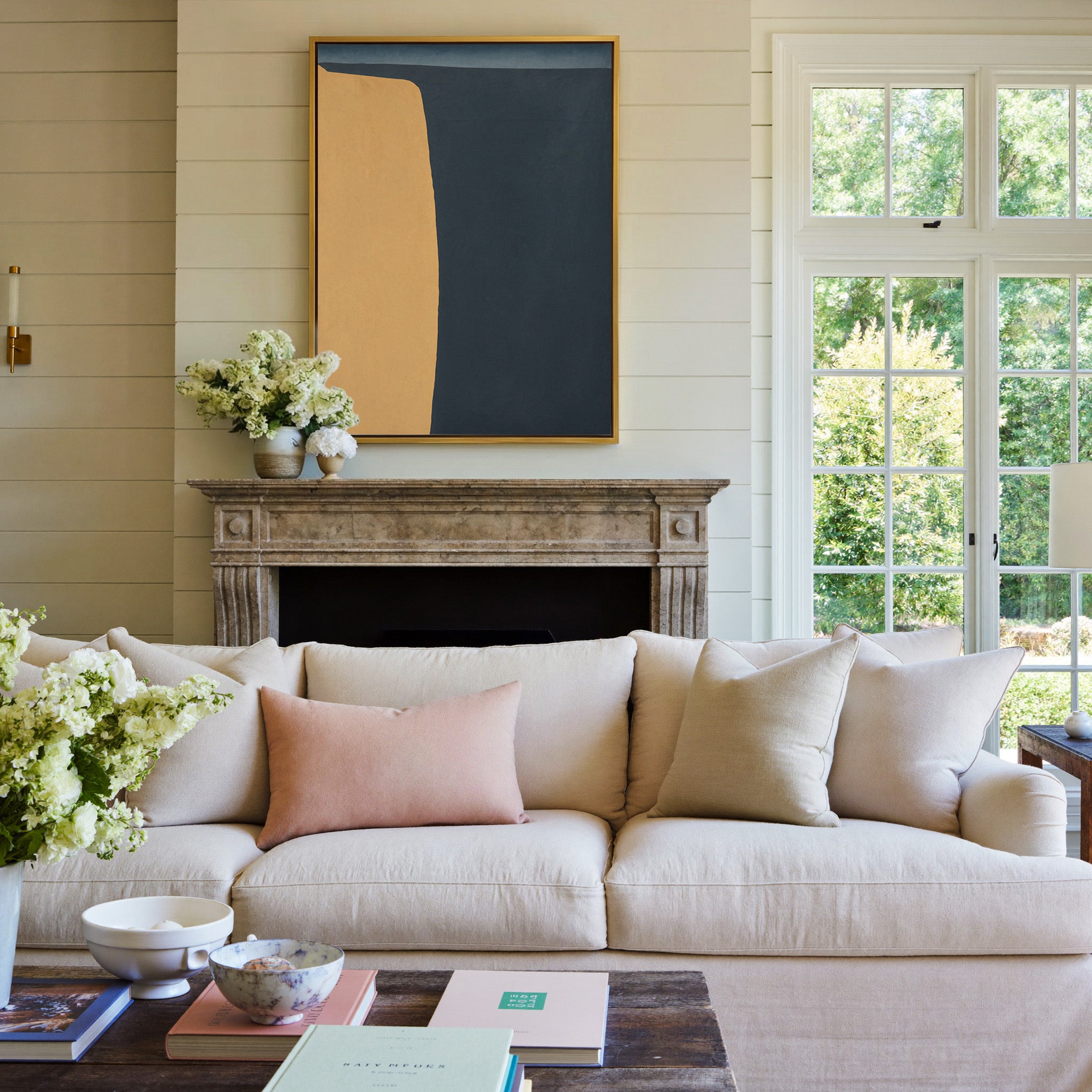navy and ochre abstract with a tall curved block canvas wall art in a gold frame above a mantel