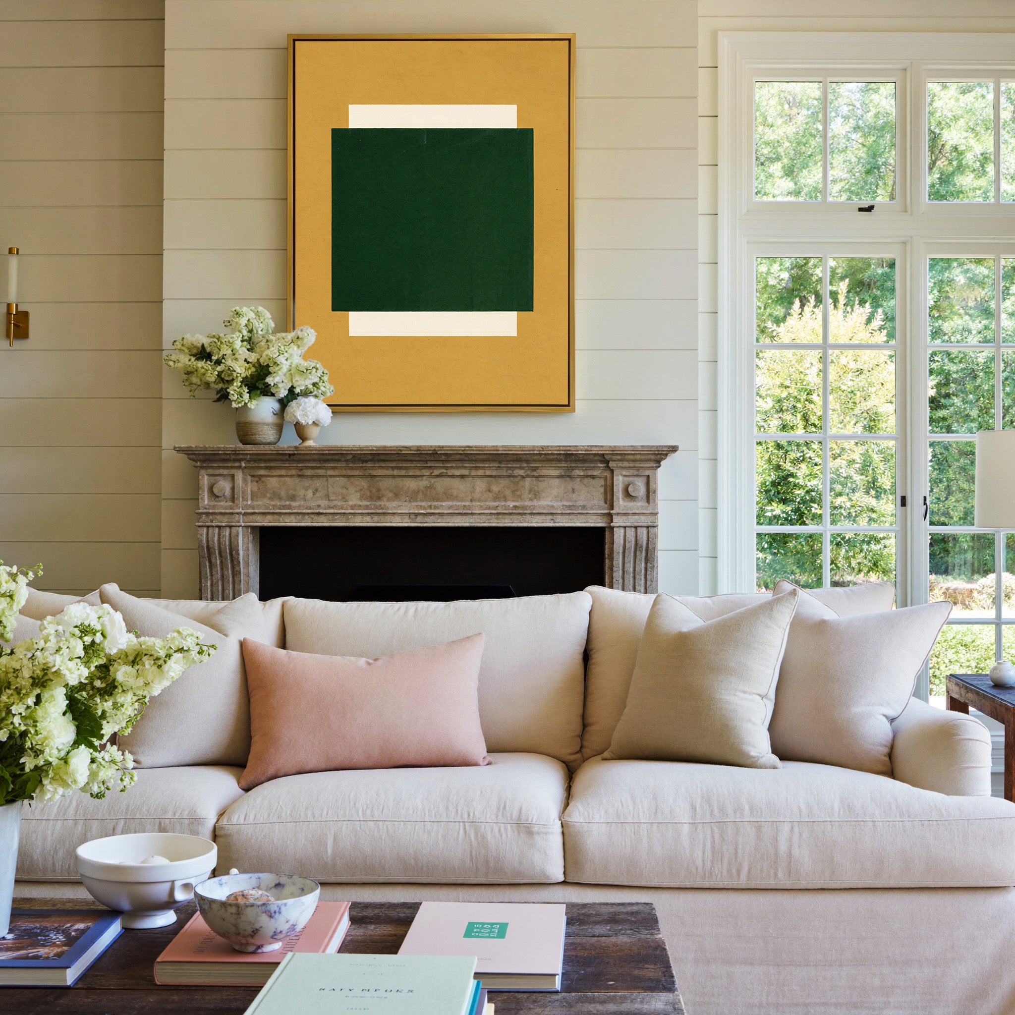 deep green block on ochre ground canvas wall art in a gold frame above a mantel