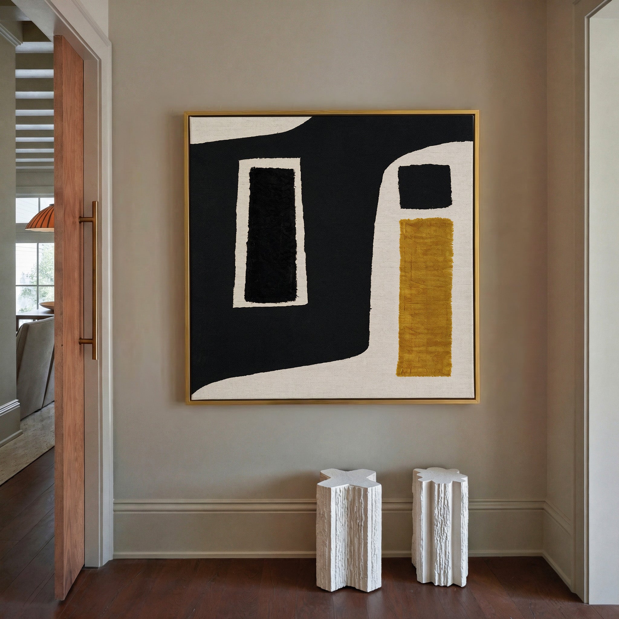 black and ochre abstract with framed blocks canvas wall art in a gold frame in a styled room setting