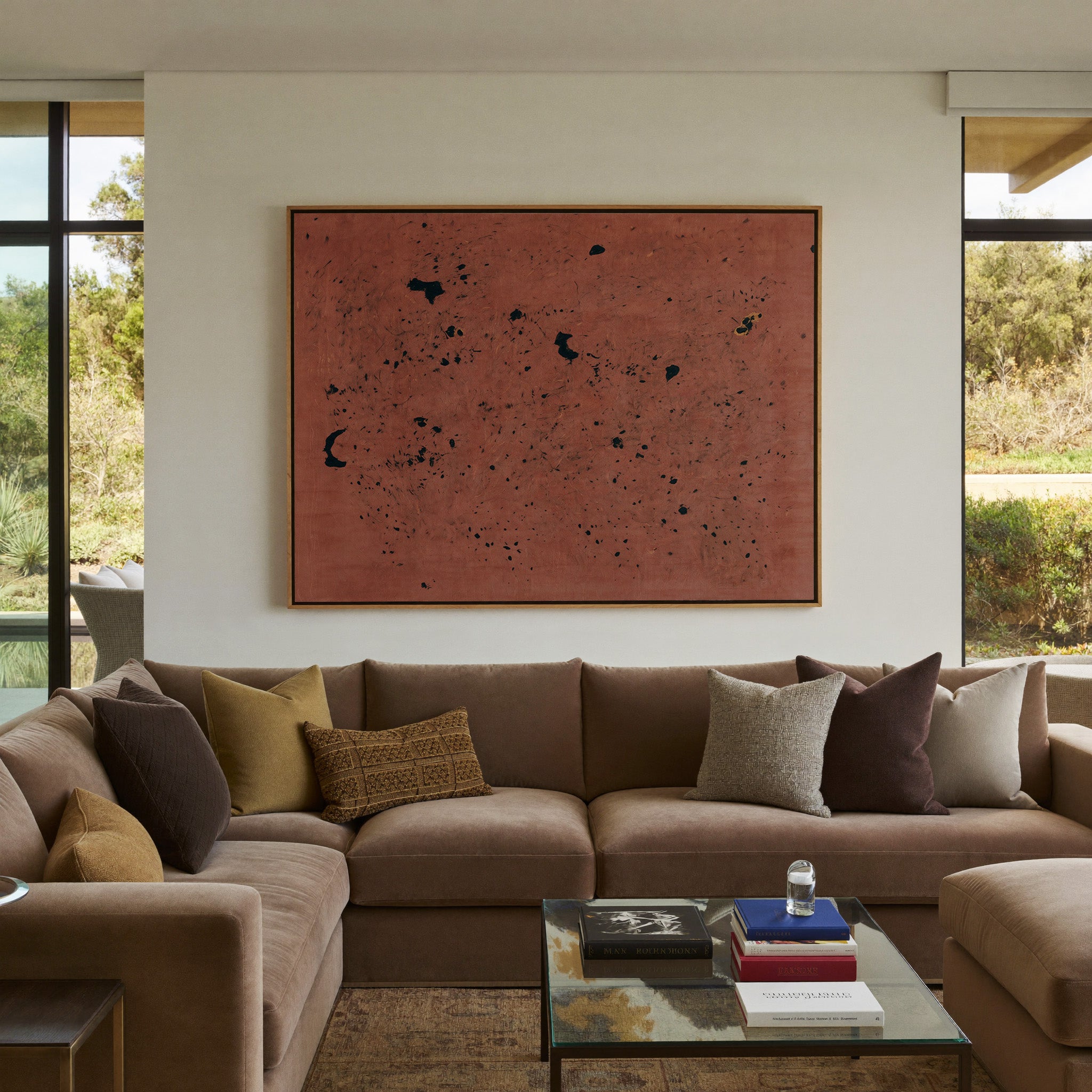 rust red abstract with scattered black marks canvas wall art in an oak frame in a styled room setting