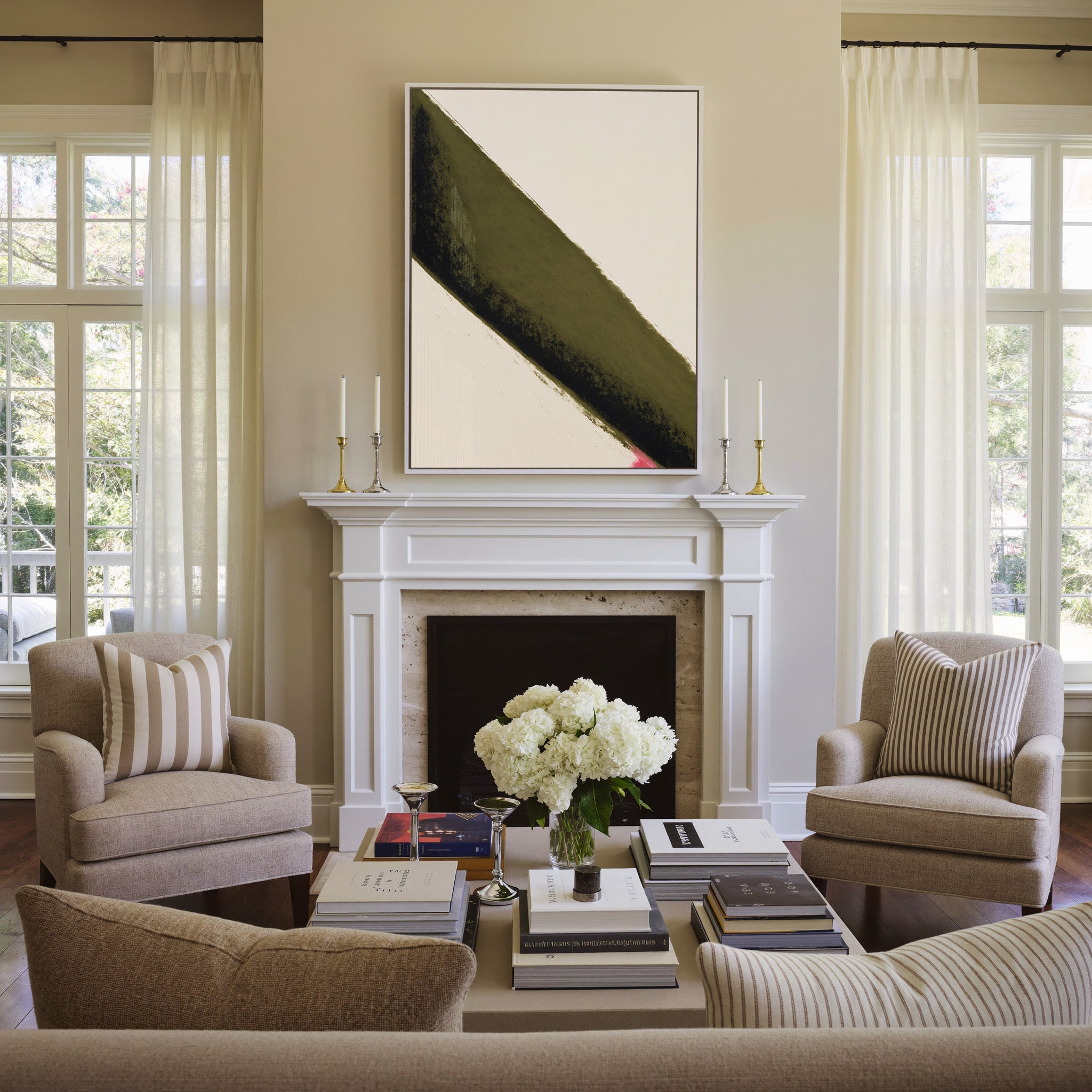 olive green diagonal band with black edge and canvas wall art in a white frame above a mantel