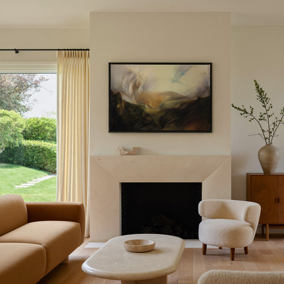 misty mountain landscape with dark foreground canvas wall art in a black frame above a mantel