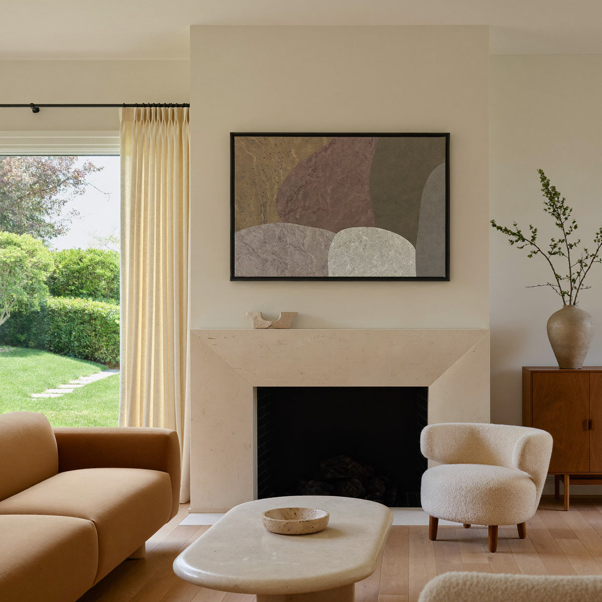earthy abstract with arched stone like forms canvas wall art in a black frame above a mantel