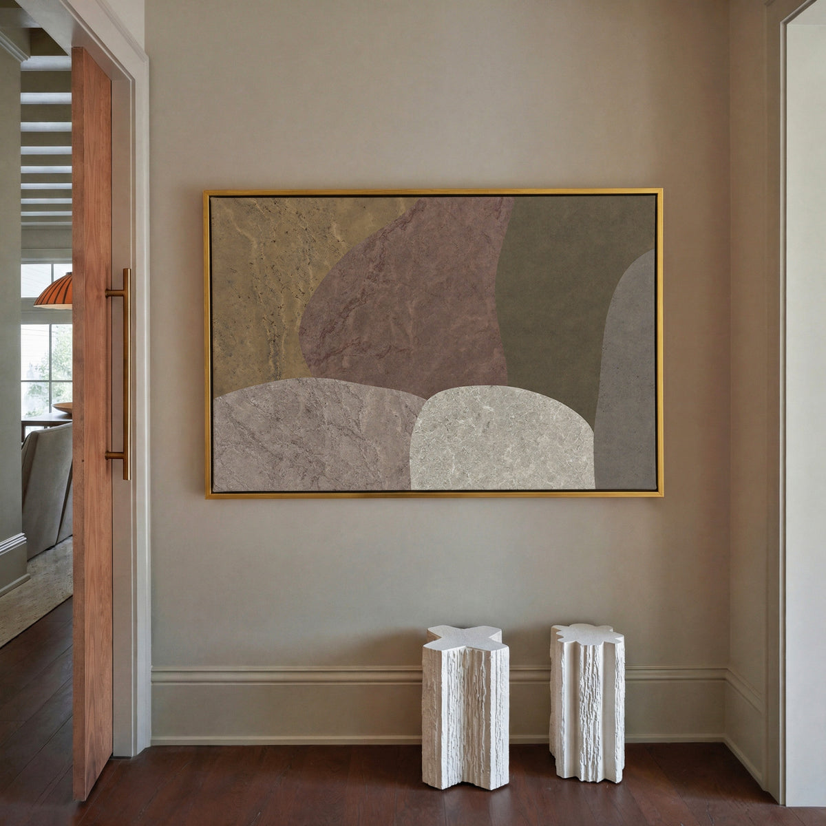 earthy abstract with arched stone like forms canvas wall art in a gold frame in a styled room setting