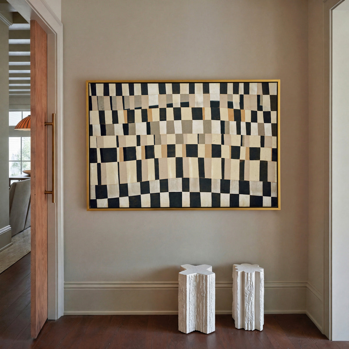 curved black, cream, and tan checker abstract canvas wall art in a gold frame in a styled room setting