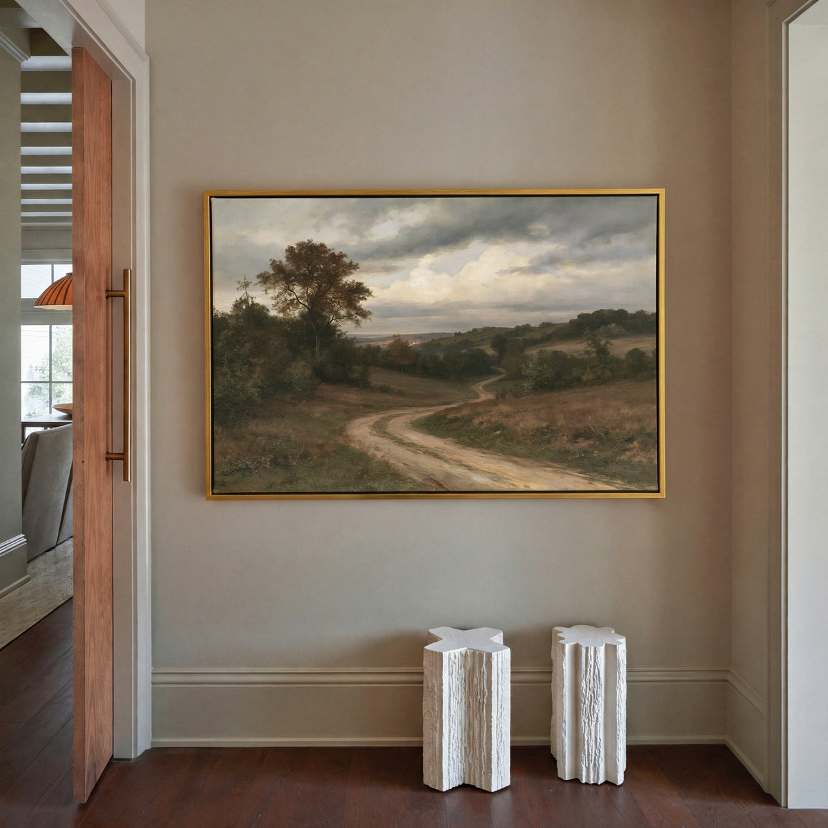soft brown countryside with a winding dirt road canvas wall art in a gold frame in a styled room setting