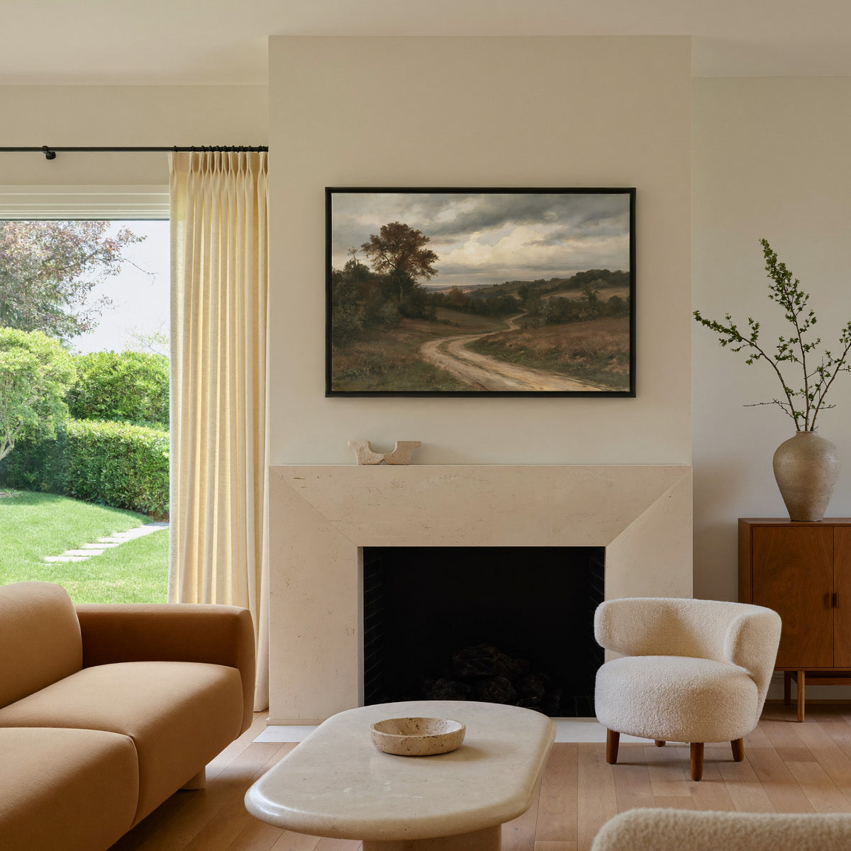 soft brown countryside with a winding dirt road canvas wall art in a black frame above a mantel