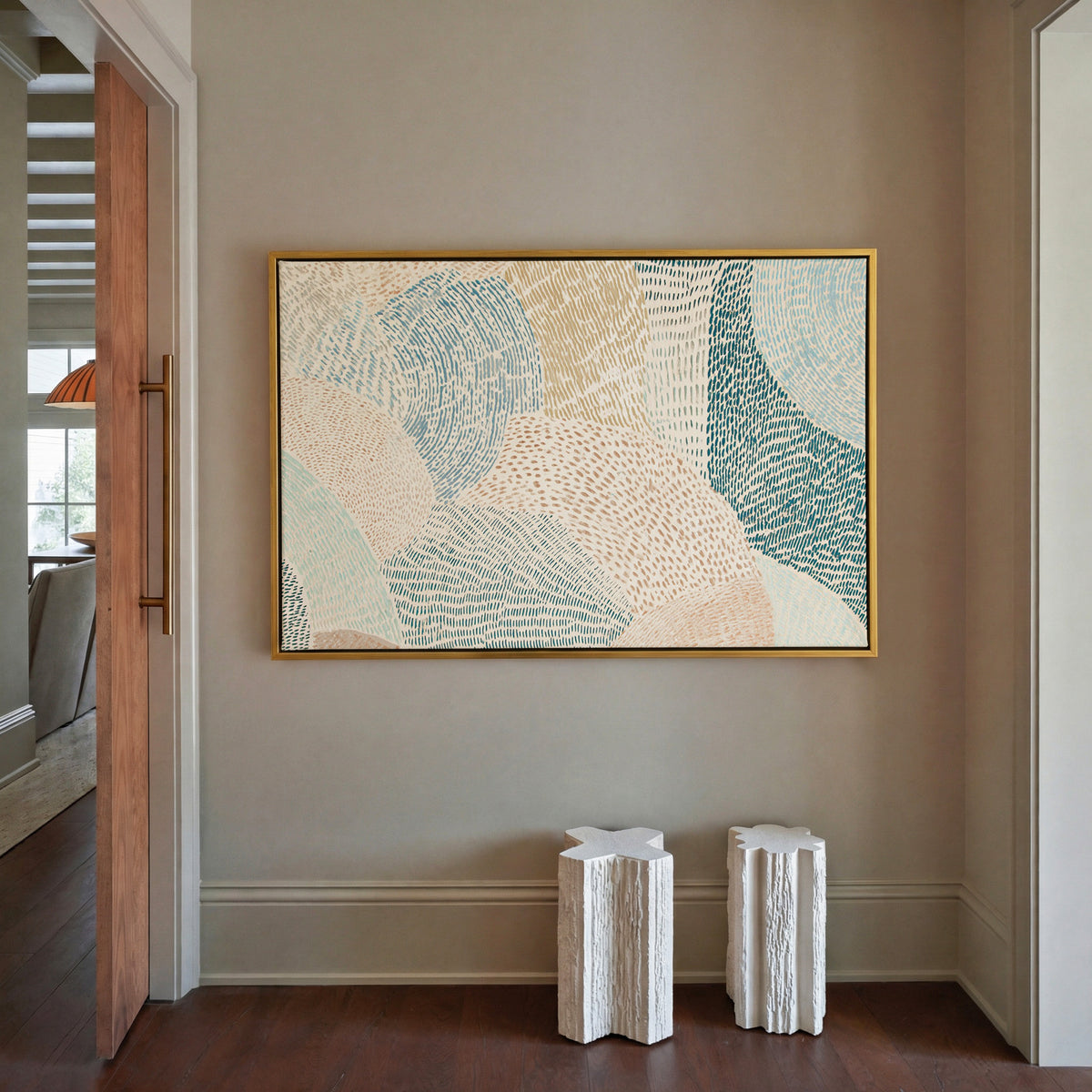 soft coastal abstract with layered teal, aqua, canvas wall art in a gold frame in a styled room setting