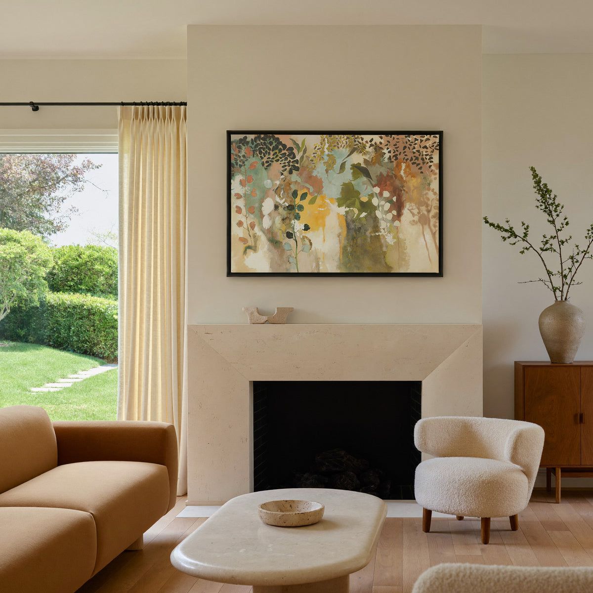 soft botanical abstract with olive, saffron, canvas wall art in a black frame above a mantel