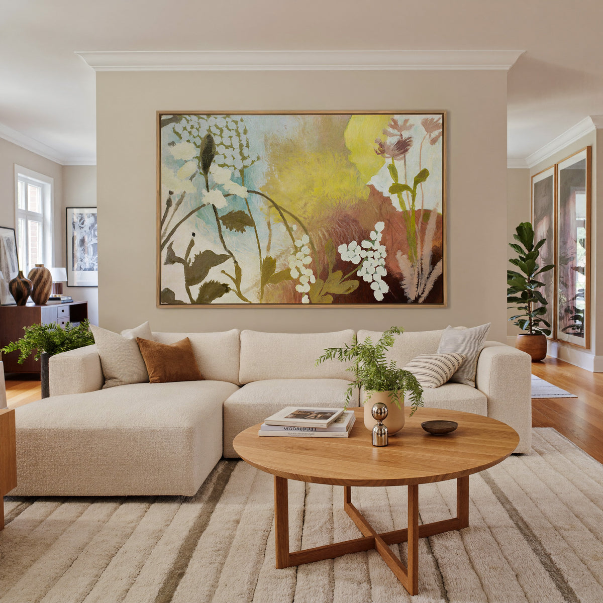 soft wildflower abstract with yellow, blush, canvas wall art in an oak frame in a living room