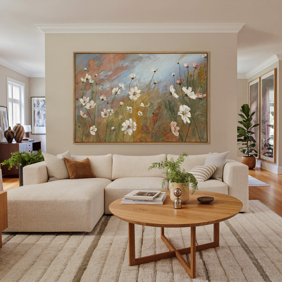 soft wildflower meadow with white and blush canvas wall art in an oak frame in a living room