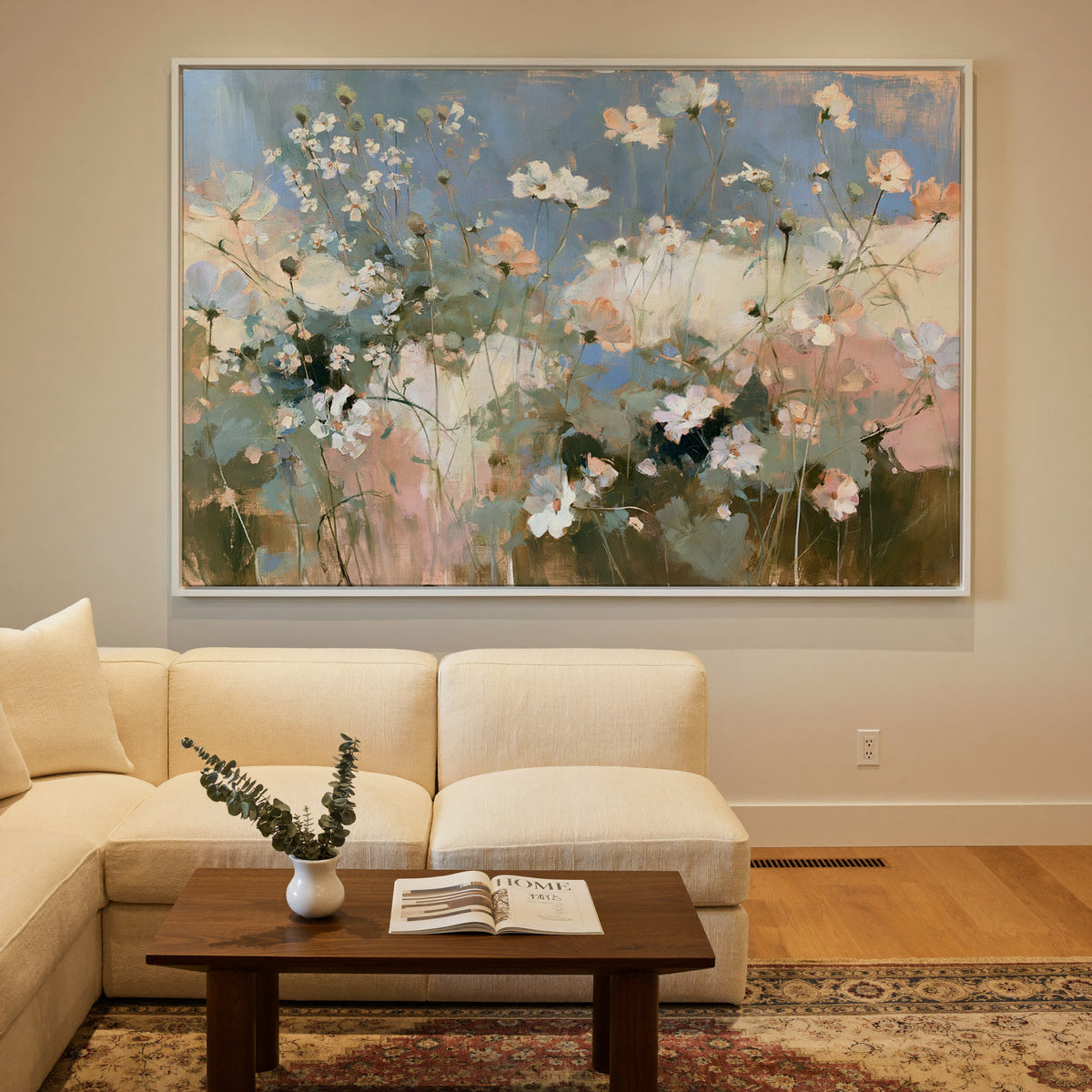 soft white and blush wildflowers under a blue canvas wall art in a white frame in a styled room setting
