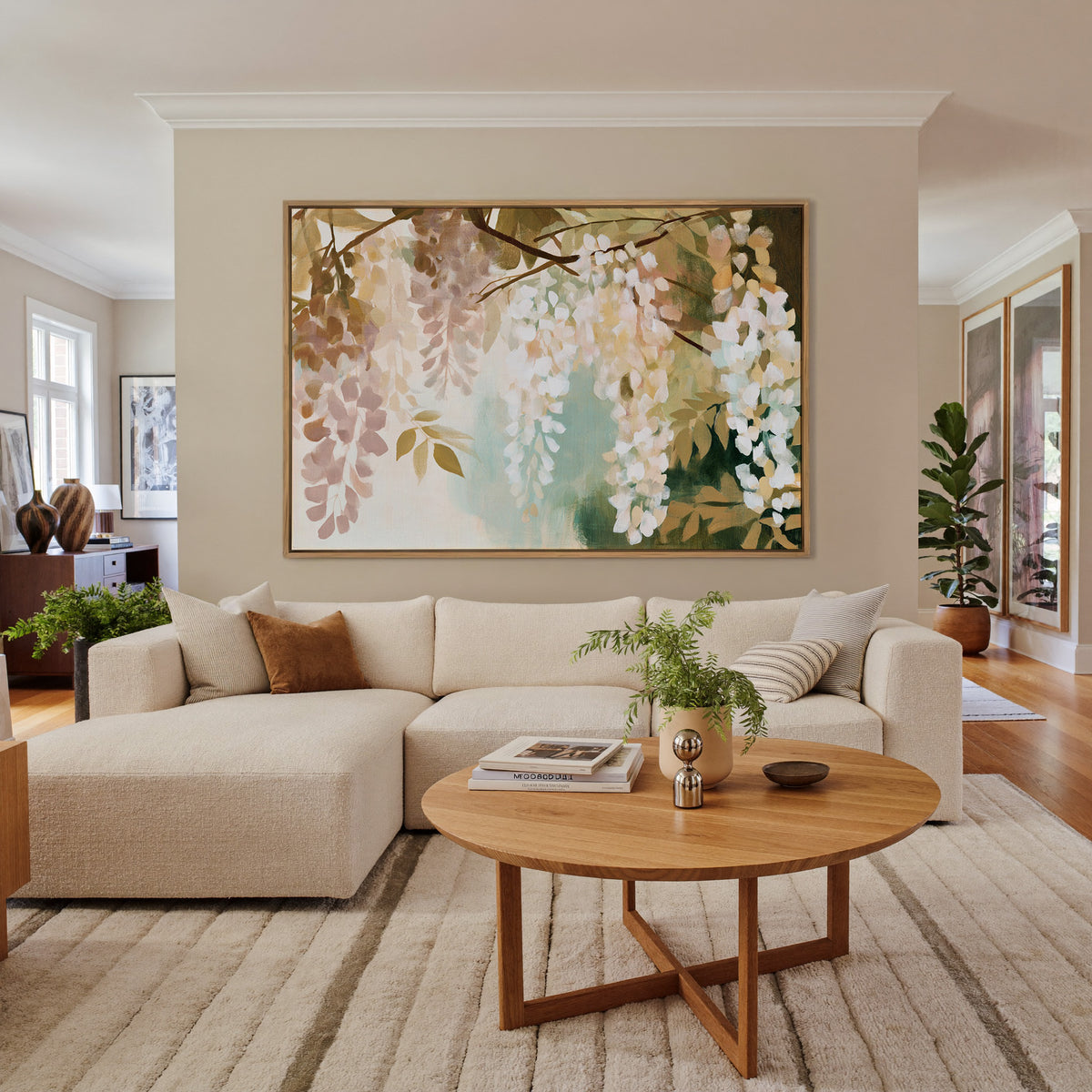 soft hanging wisteria in cream, blush, and sage canvas wall art in an oak frame in a living room
