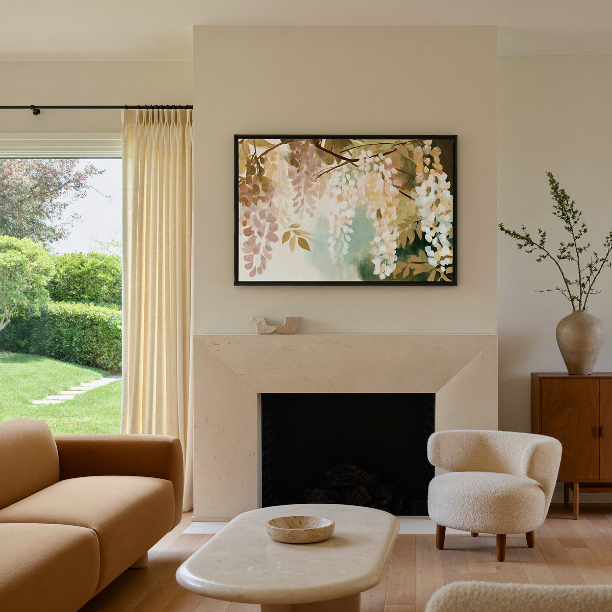 soft hanging wisteria in cream, blush, and sage canvas wall art in a black frame above a mantel