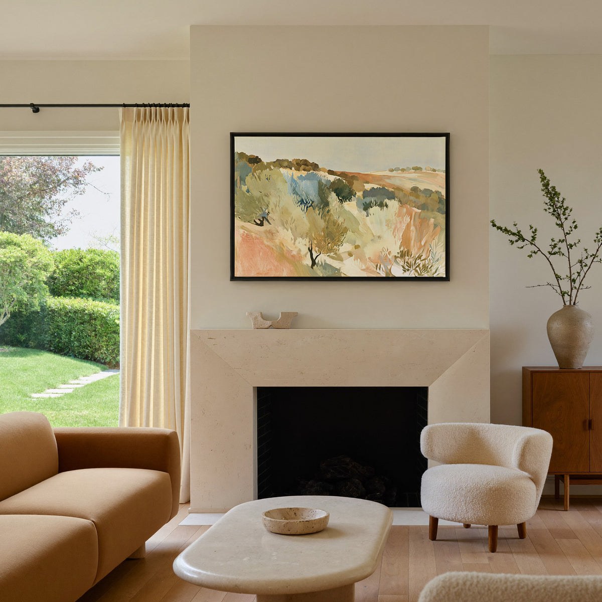warm hillside olive orchard with pale sky and canvas wall art in a black frame above a mantel