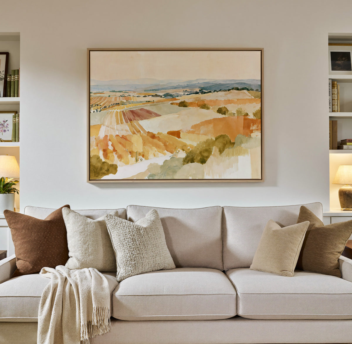 soft vineyard hills in ochre, cream, and blue canvas wall art in a natural wood frame in a styled room setting