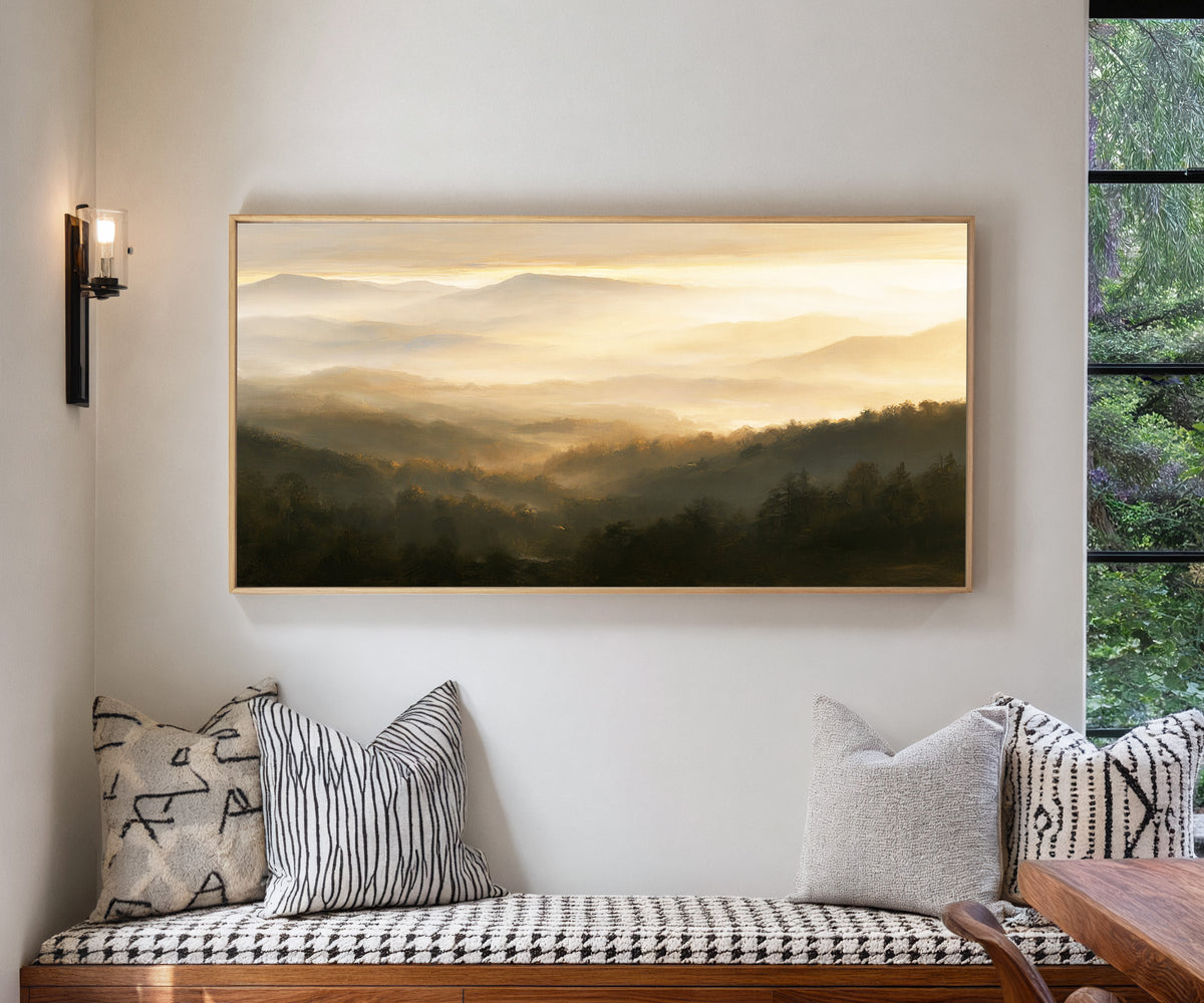 layered misty mountain landscape at sunrise canvas wall art in a natural wood frame in a living room