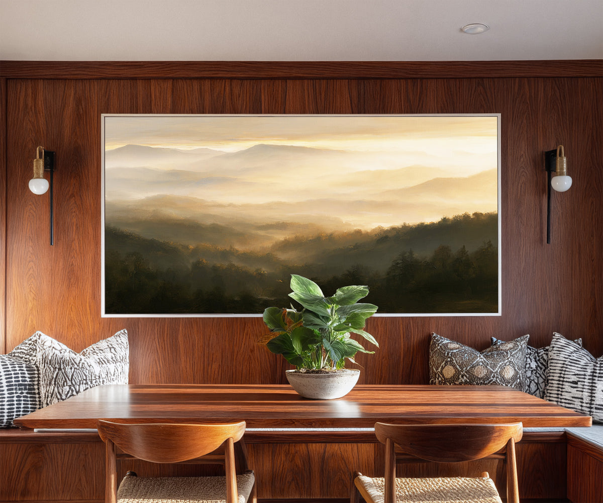 layered misty mountain landscape at sunrise canvas wall art in a white frame in a styled room setting