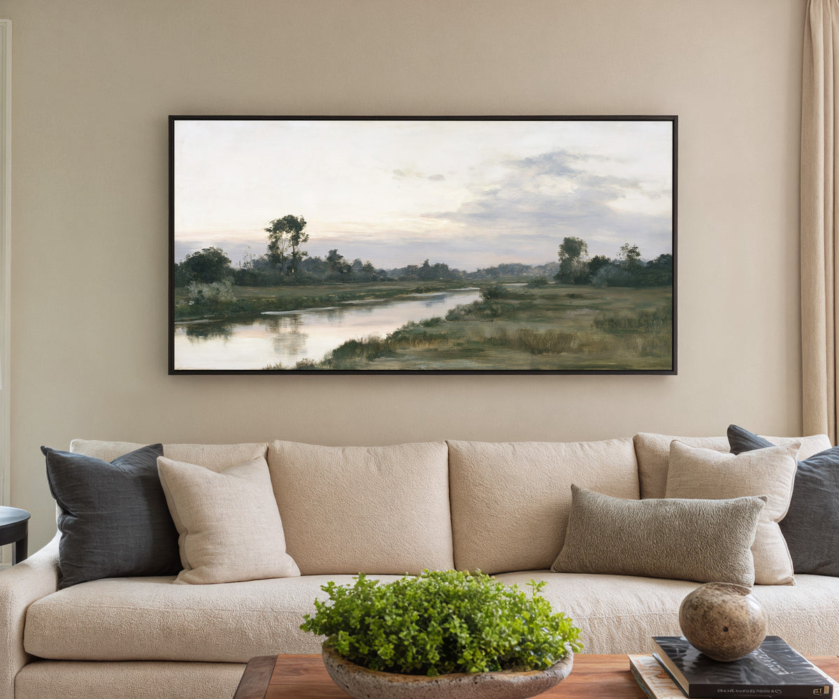 quiet river meadow at first light canvas wall art in a black frame in a styled room setting