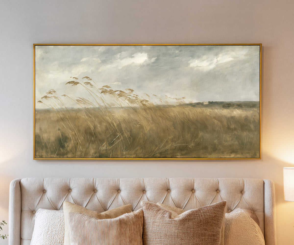 wide field of tall grasses bending in one canvas wall art in a gold frame above a bed