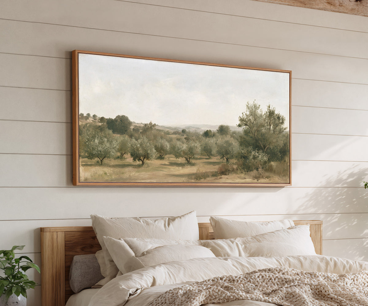 late summer orchard with uneven rows of small canvas wall art in an oak frame above a bed