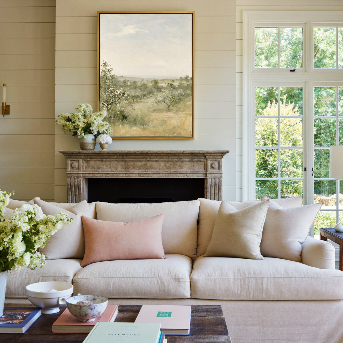 late summer orchard with uneven rows of small canvas wall art in a gold frame above a mantel
