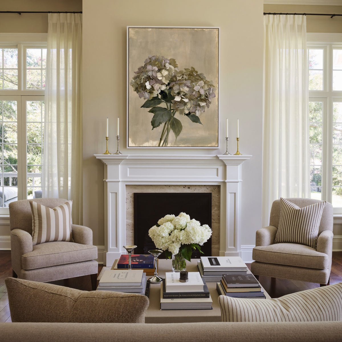 faded hydrangea cluster in cream, mauve, and canvas wall art in a white frame above a mantel
