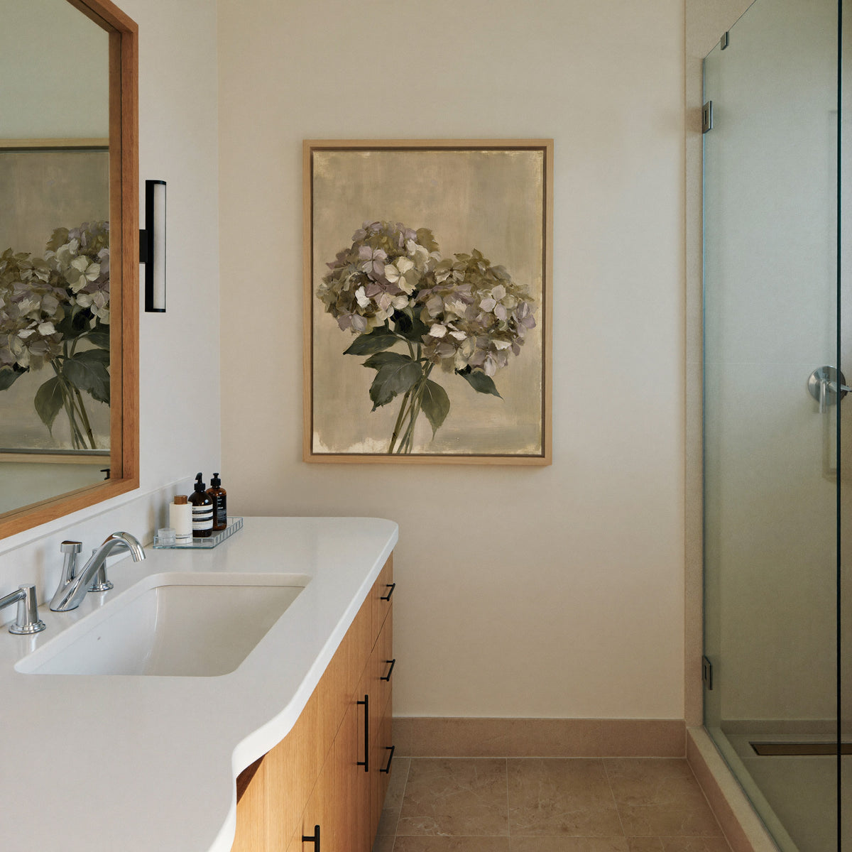 faded hydrangea cluster in cream, mauve, and canvas wall art in a natural wood frame in a styled room setting