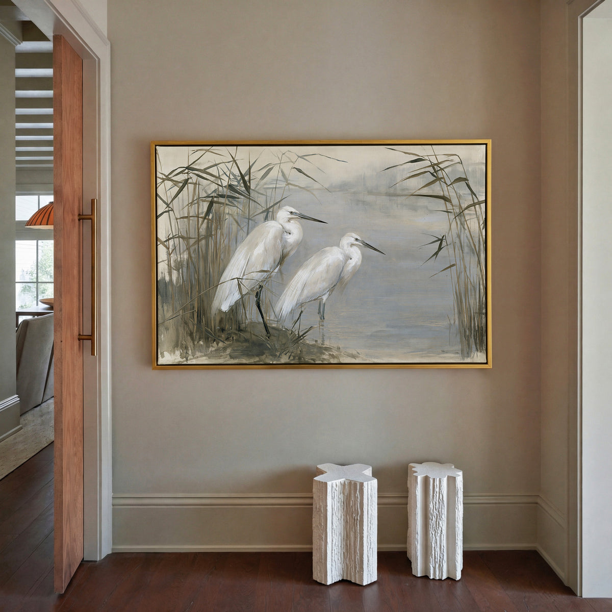 pair of white herons among tall reeds canvas wall art in a gold frame in a styled room setting