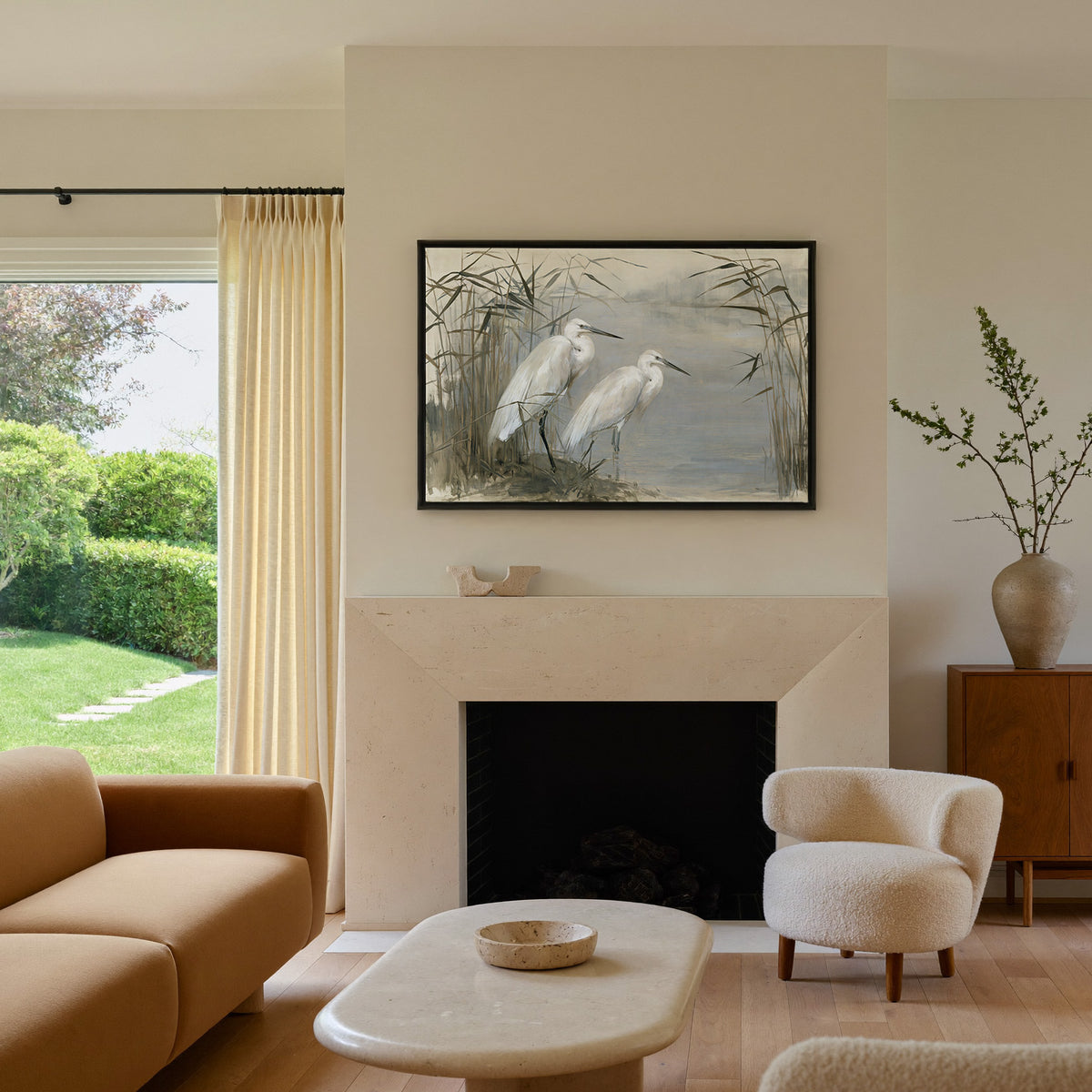 pair of white herons among tall reeds canvas wall art in a black frame above a mantel