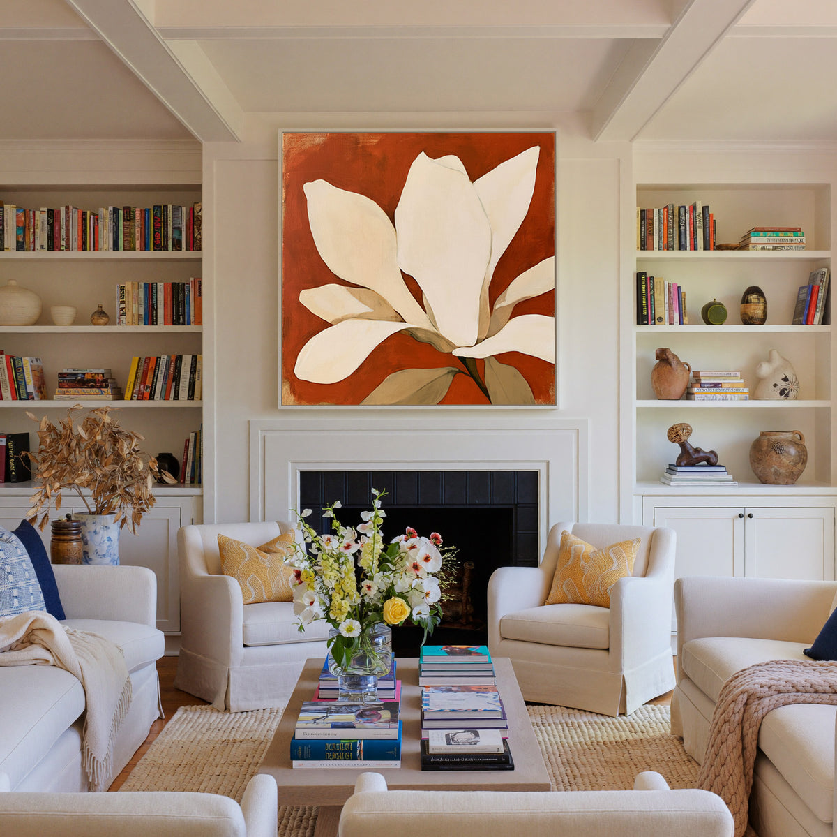 oversized ivory magnolia against terracotta canvas wall art in a white floater frame above a fireplace