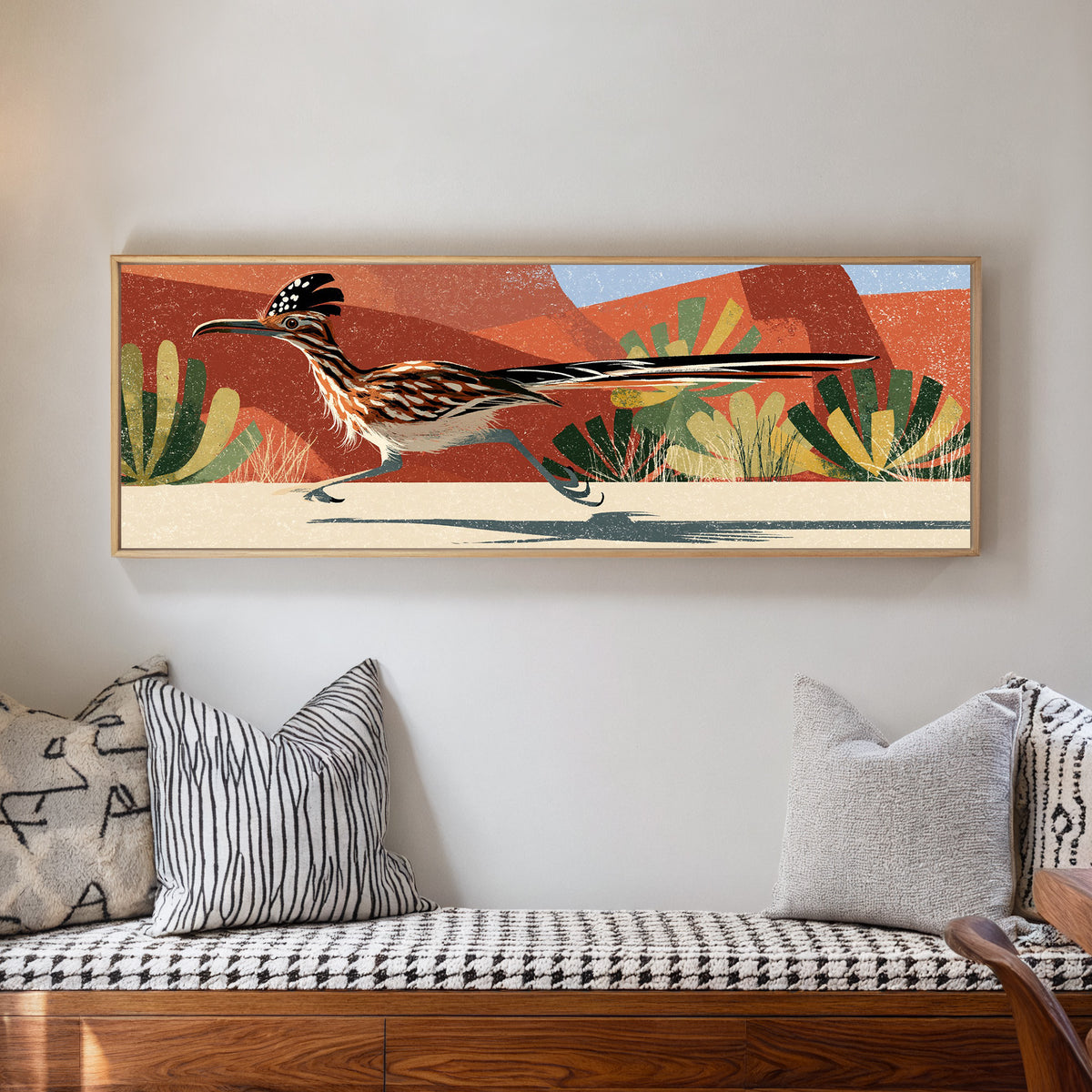 long tailed roadrunner crossing terracotta canvas wall art in a natural floater frame in a living room