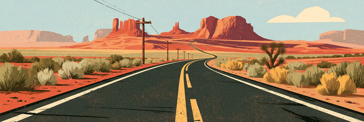 Winding desert highway with yellow lines, terracotta mesas, olive shrubs, and a pale blue sky