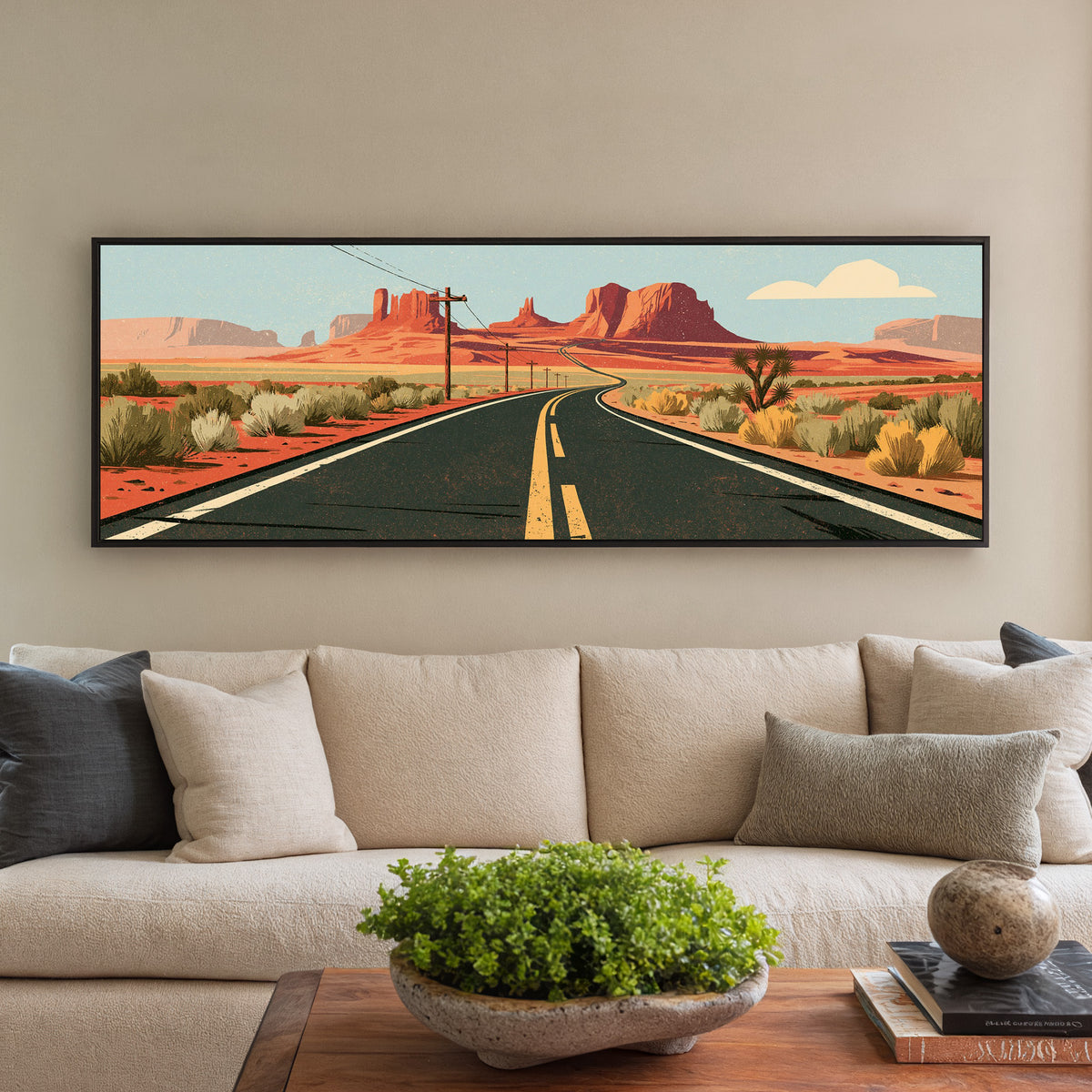 winding desert highway beneath canvas wall art in a black floater frame in a styled room setting