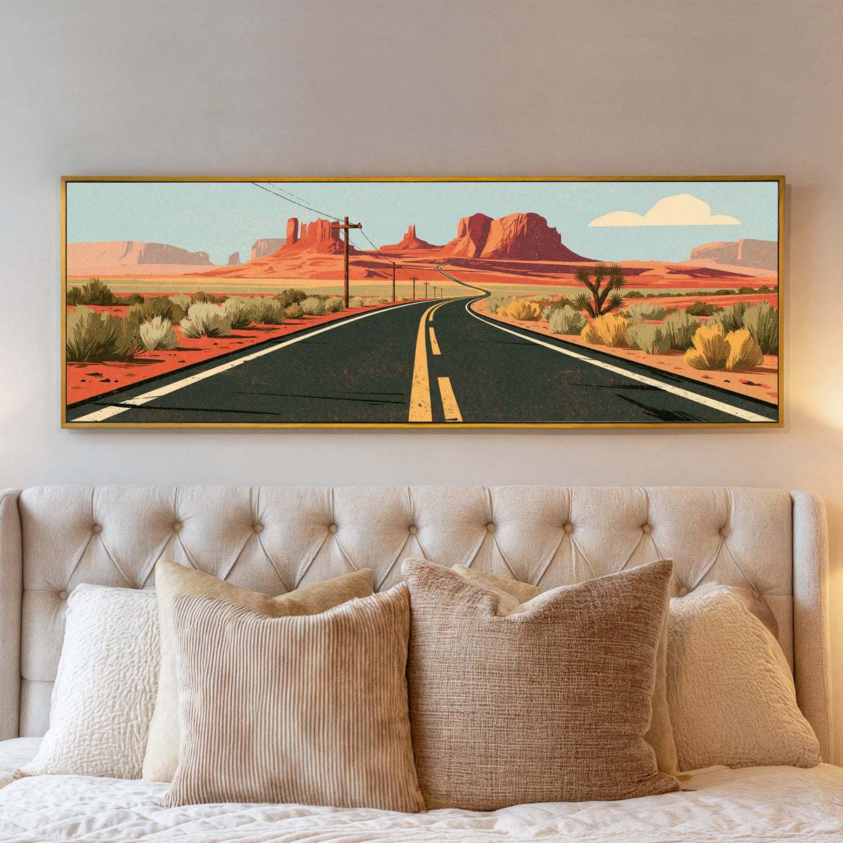 winding desert highway beneath terracotta mesas canvas wall art in a gold floater frame above a bed