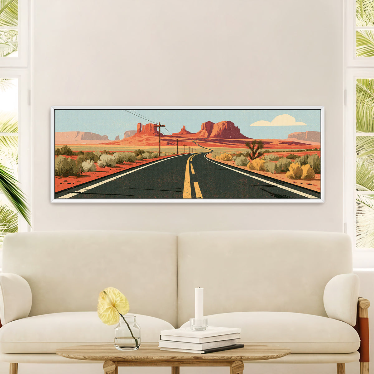 winding desert highway beneath canvas wall art in a white floater frame in a styled room setting