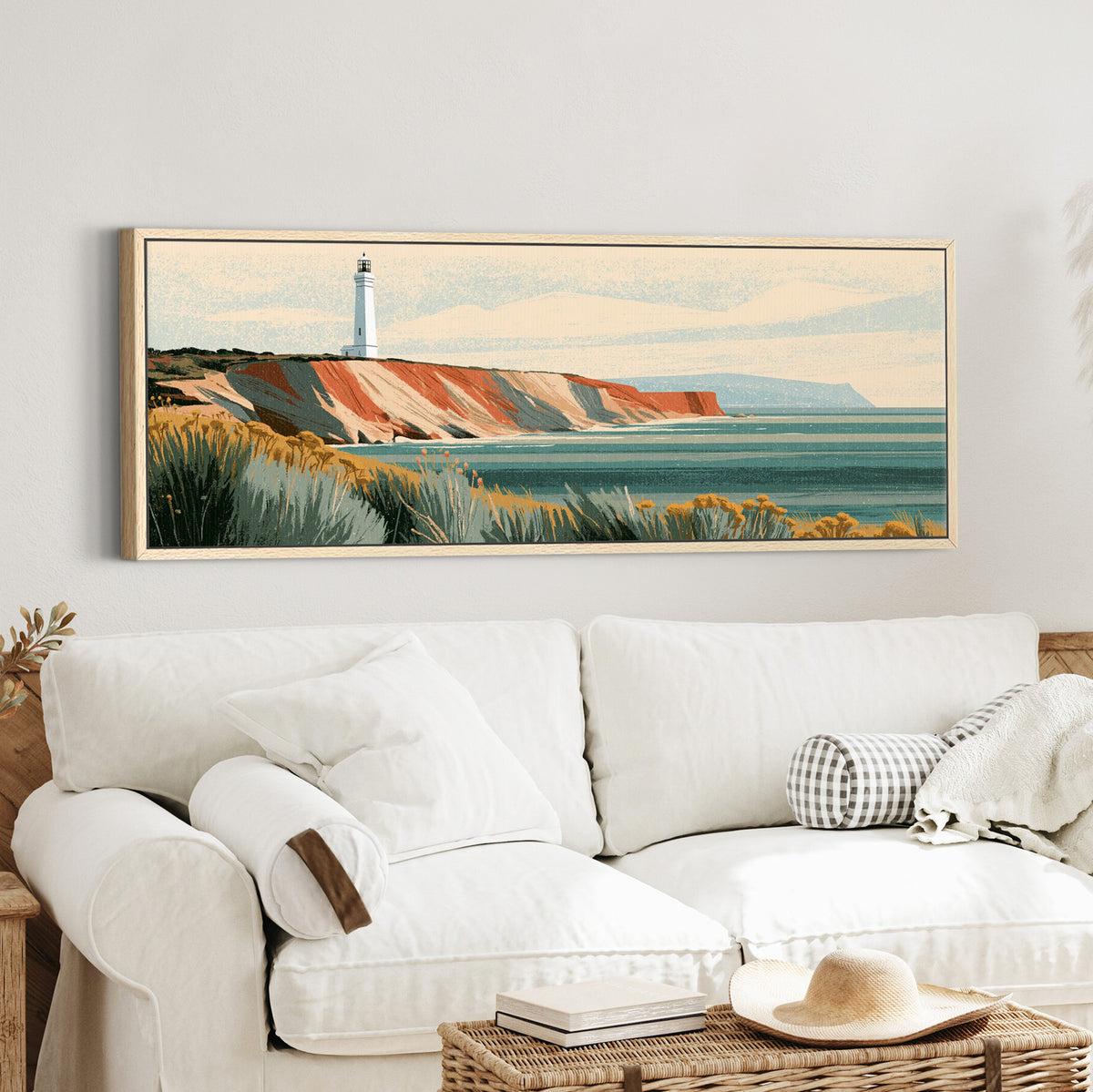 white lighthouse above terracotta canvas wall art in an oak finish floater frame in a styled room setting